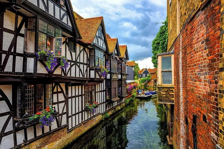 Historic half-timbered houses lining a narrow canal in a quaint town