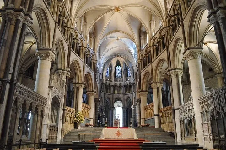 Interior of a grand cathedral with high vaulted ceilings and an altar